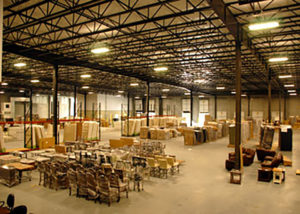 A warehouse filled with lots of tables and chairs.