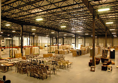 A warehouse filled with lots of tables and chairs.