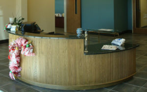 A counter in an office building with papers on the counter.