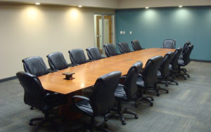 A large conference room with chairs around it.
