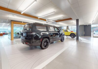 A black suv is parked in a showroom.