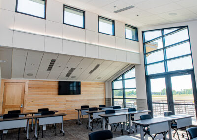Classroom with desks and windows overlooking a runway.