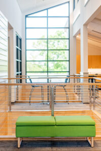 Green bench in a modern lobby.