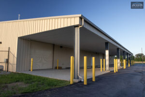 Metal building with covered parking area.