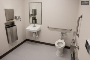 Accessible bathroom with toilet, sink, and grab bars.